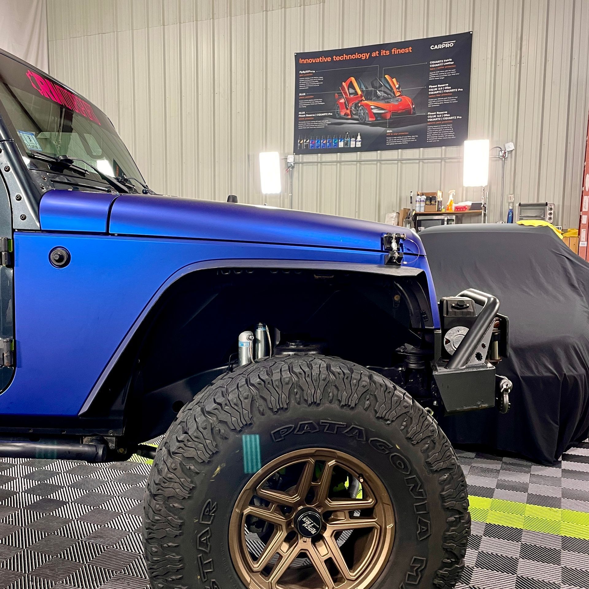 A red sports car with a license plate that says jbg is parked on the side of the road.