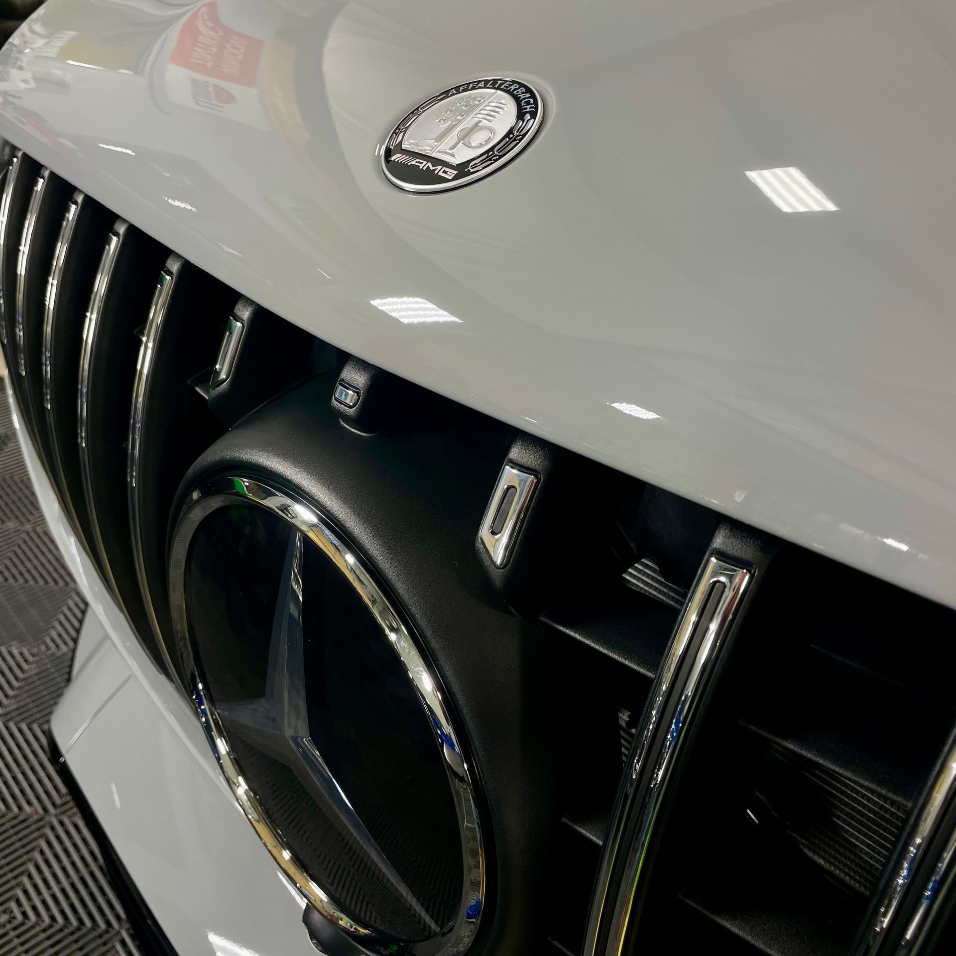 A close up of a car headlight in a garage.