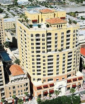 An aerial view of a large building with a pool on top of it.