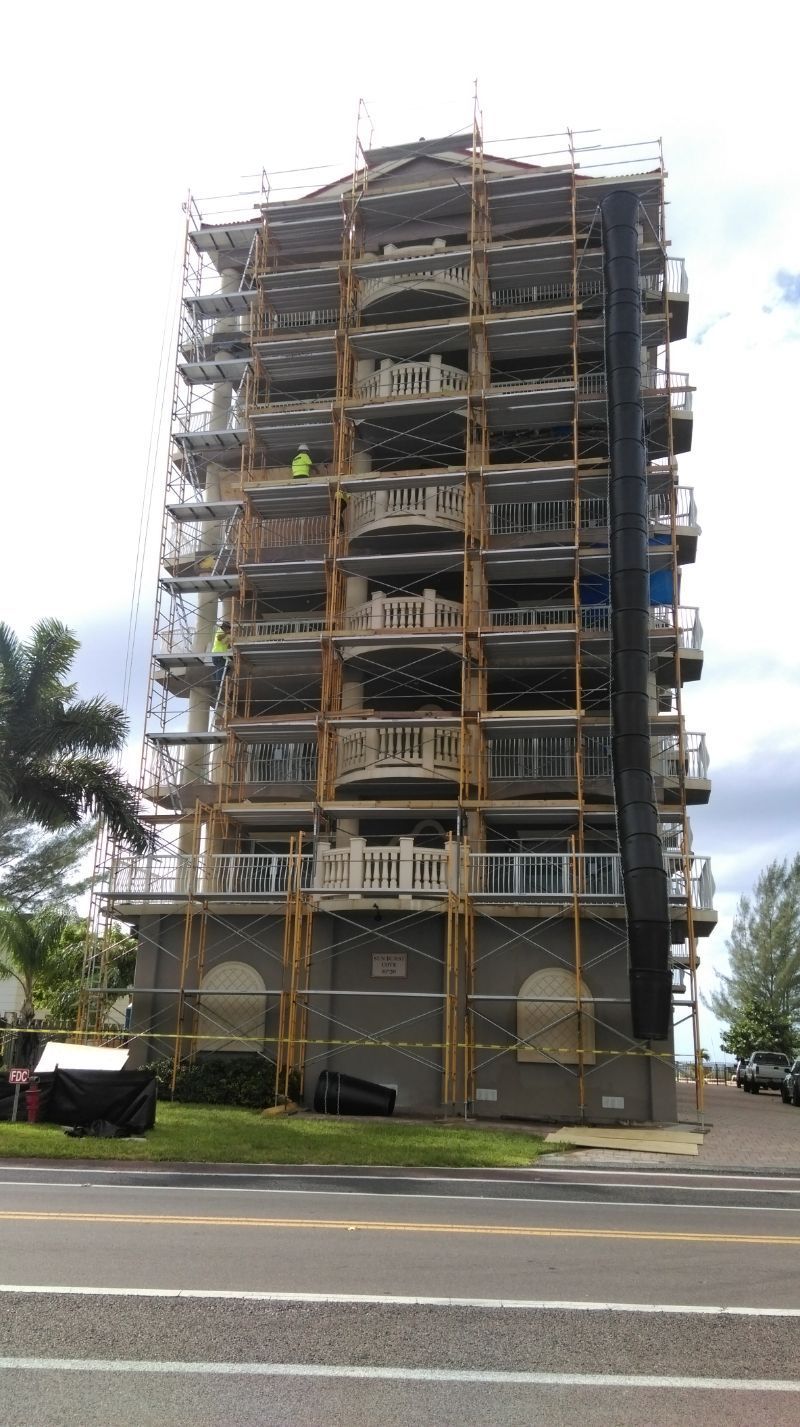 A tall building is being built with scaffolding around it.