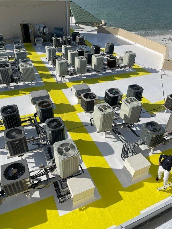 A rooftop with a lot of air conditioners on it