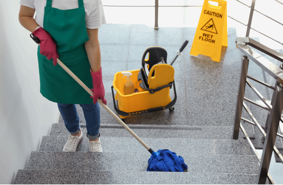 Cleaner moping staircase with mop and mop bucket.