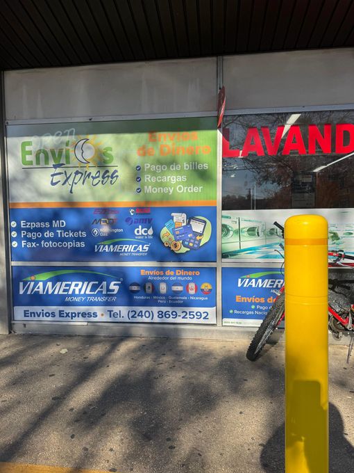 Tan commercial building with a blue sign that reads 