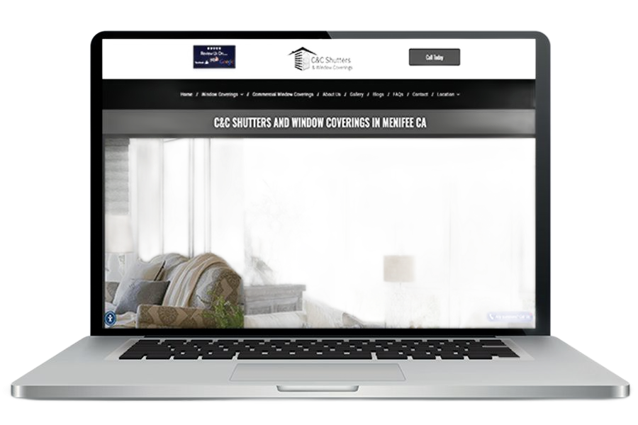 Laptop displaying a website for shutters and window coverings, with a blurred interior image.