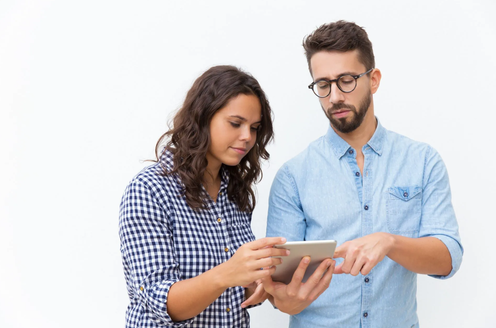 Woman and man looking at tablet; woman points, man touches screen. Plain white background.
