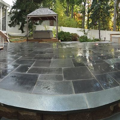 A circular patio with a gazebo in the background