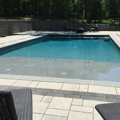 A large swimming pool with a fence around it