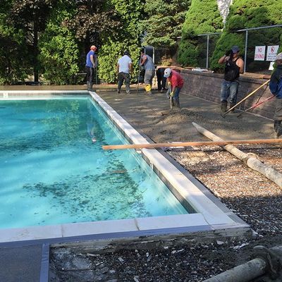 A group of people are working on a swimming pool