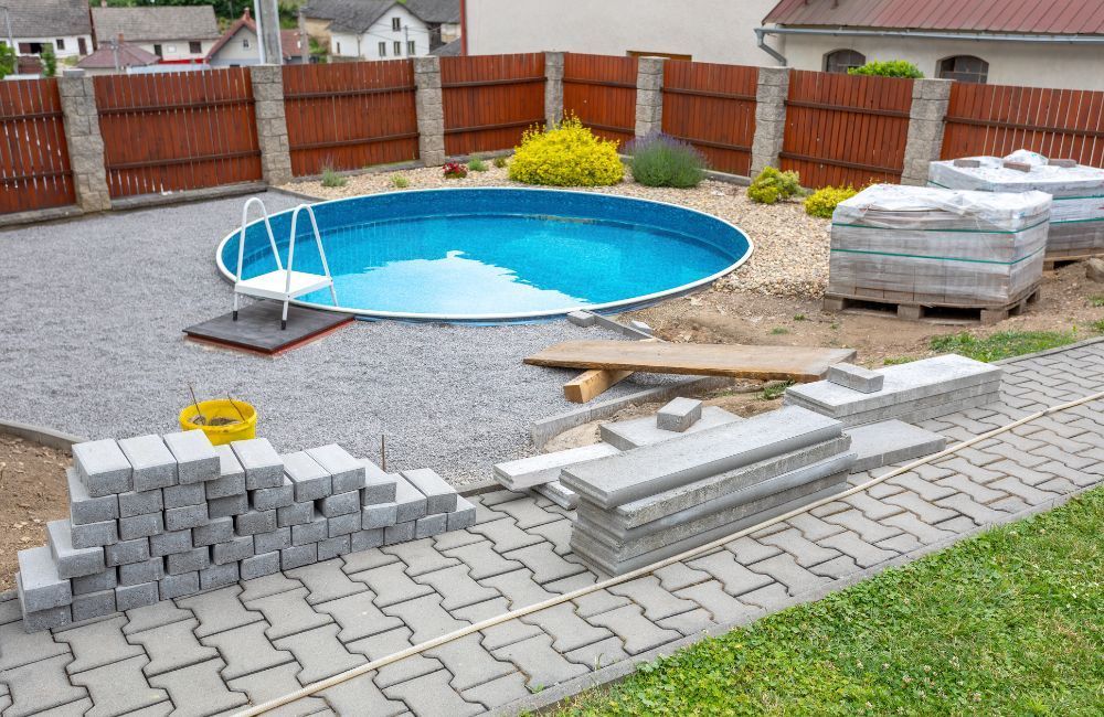 A swimming pool is being built in a backyard.