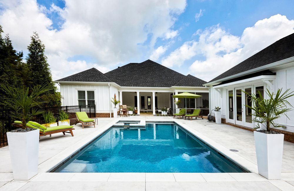 A large swimming pool in the backyard of a house