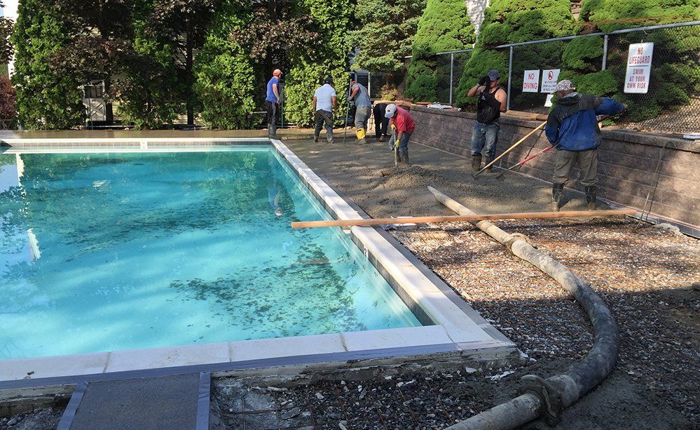 A group of people are working on a swimming pool.