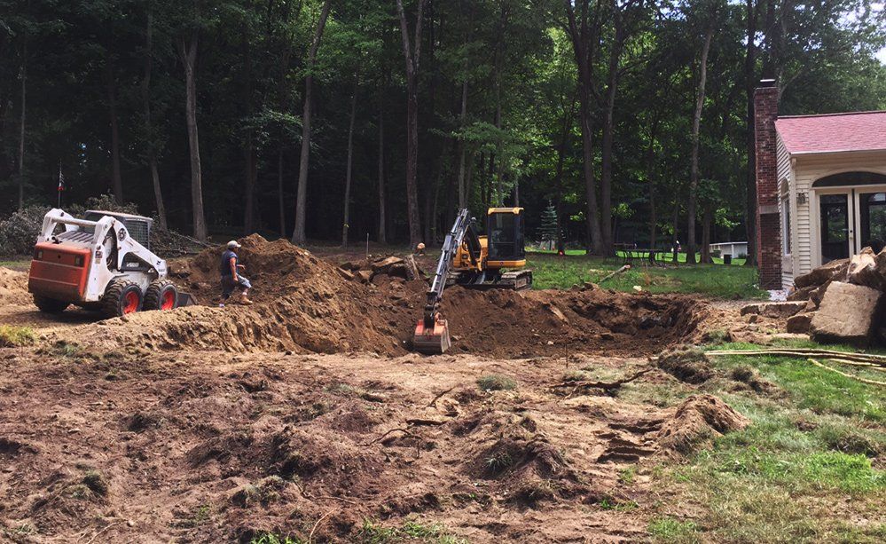 A house is being built in the middle of a dirt field.