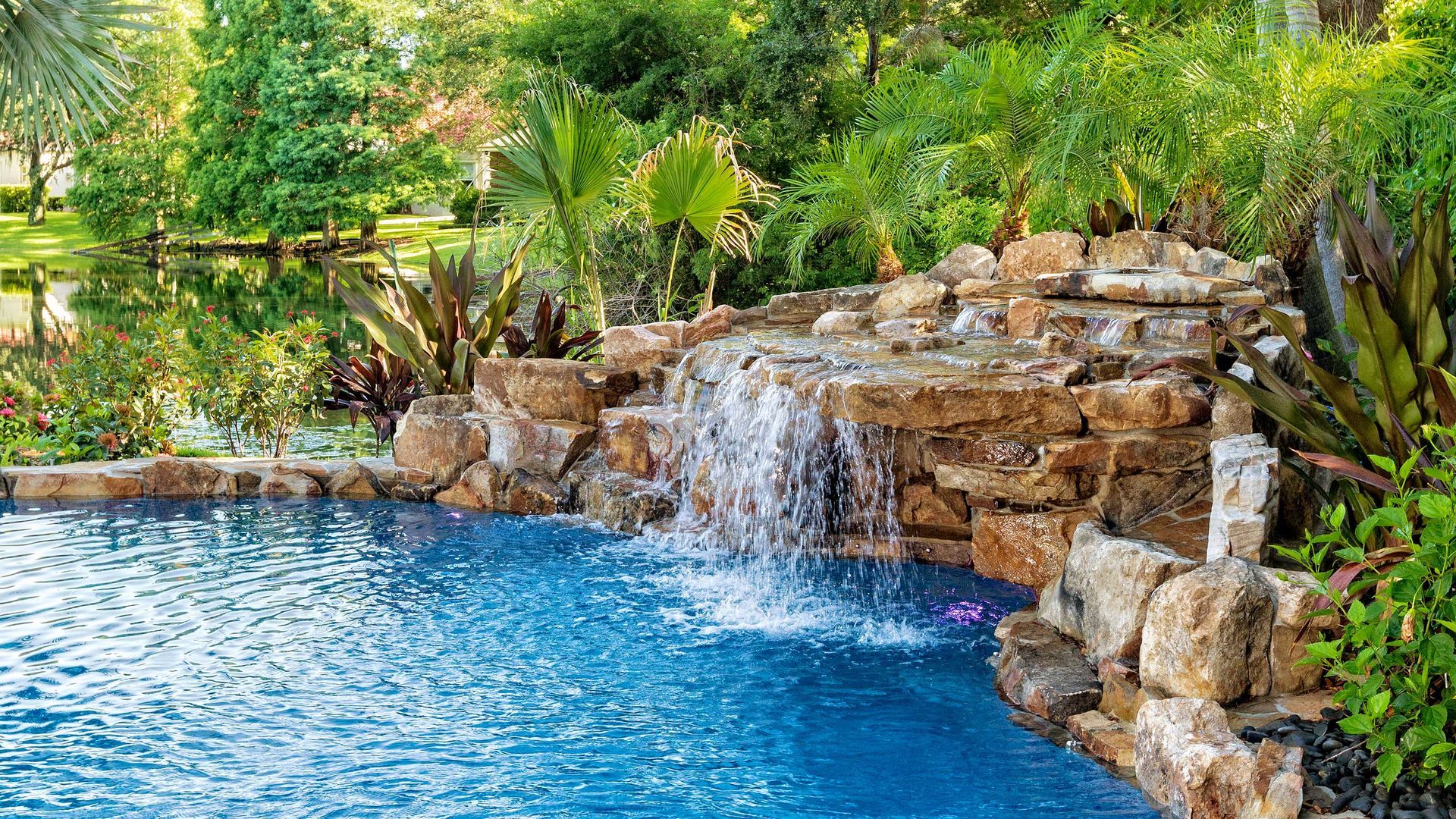 There is a waterfall in the middle of the pool.