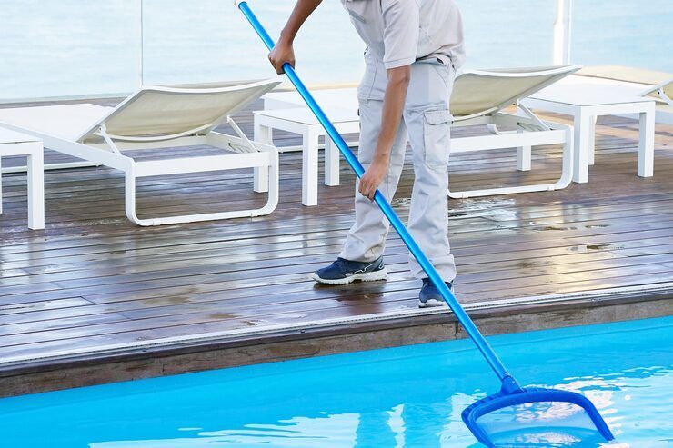 man cleaning the pool