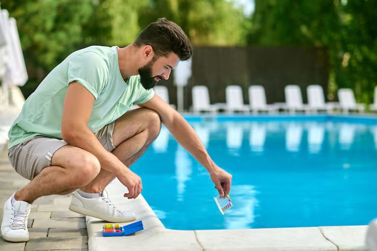 man with pool test kit swimming pool
