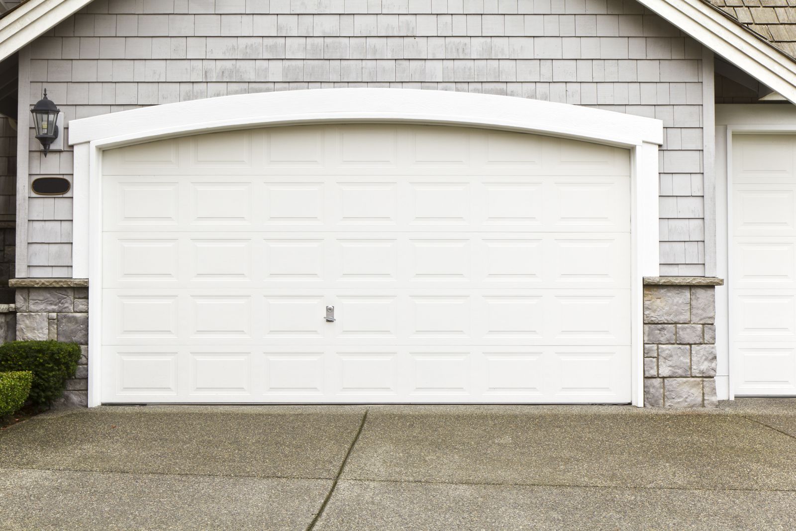 a white garage door in front of a house