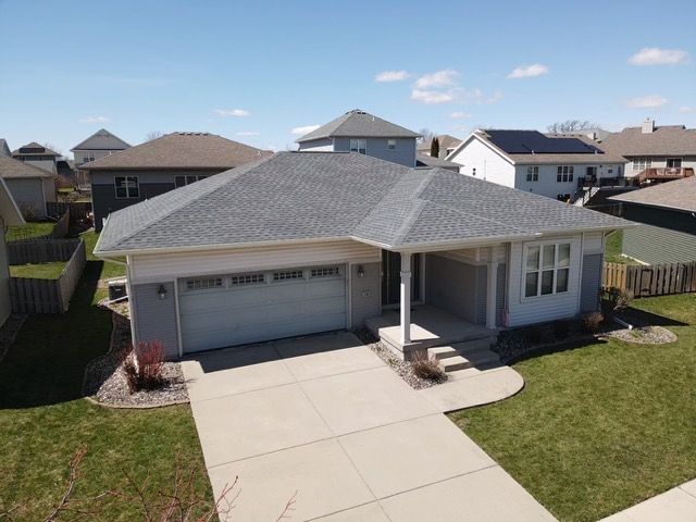 An aerial view of a house with a new gray roof
