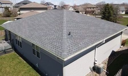 An aerial view of a house with a new roof.