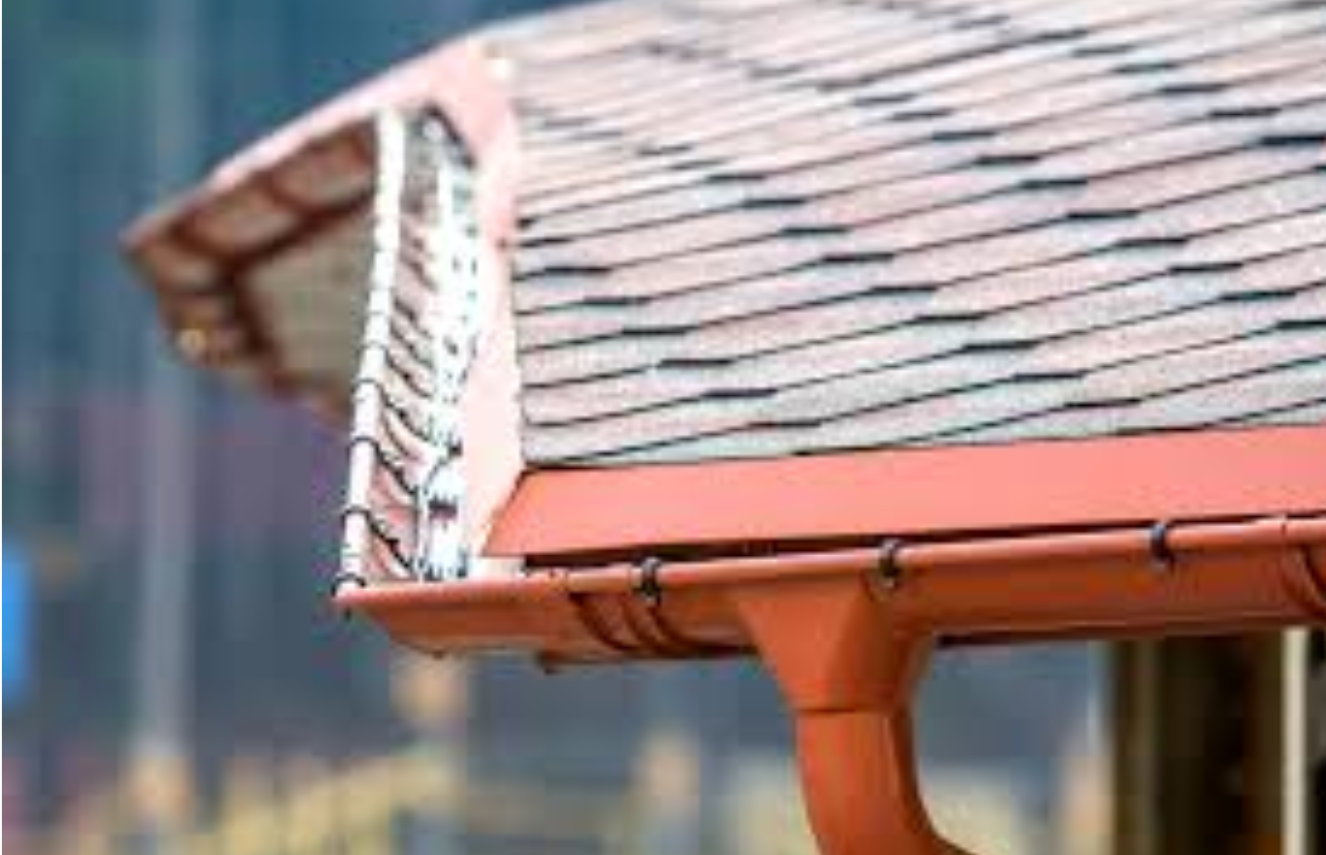 A close up of a gutter on an improperly slanted  roof of a house.