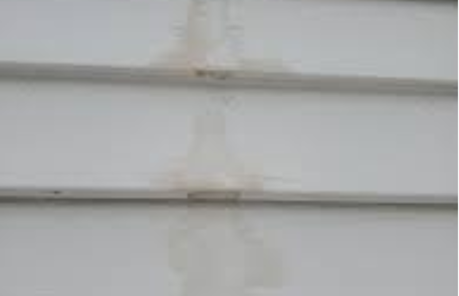 A close up of a white siding on a house.