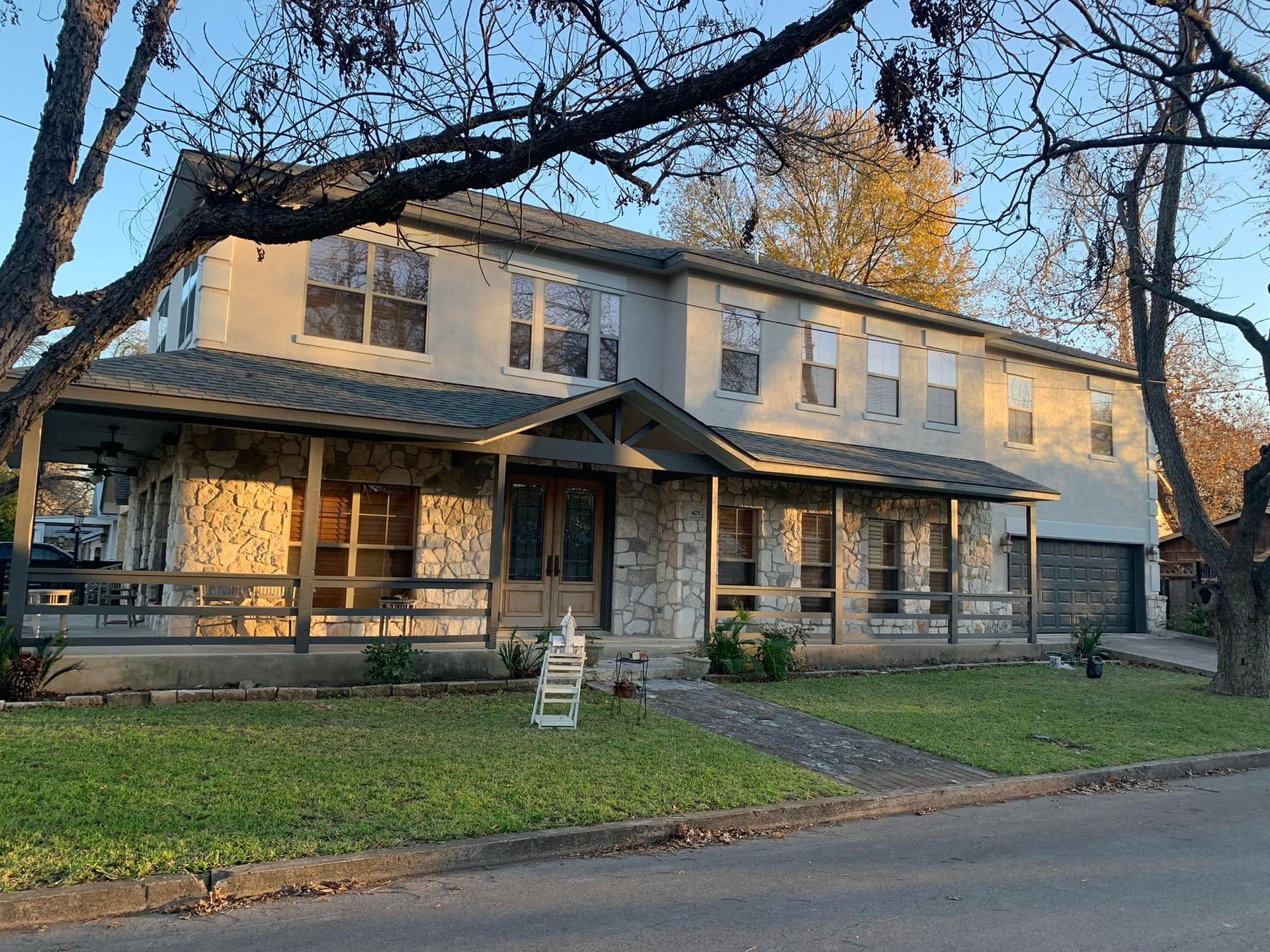 A large house with a porch and a lot of windows