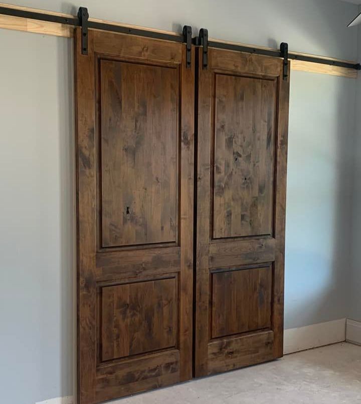 A pair of wooden sliding barn doors in a room.