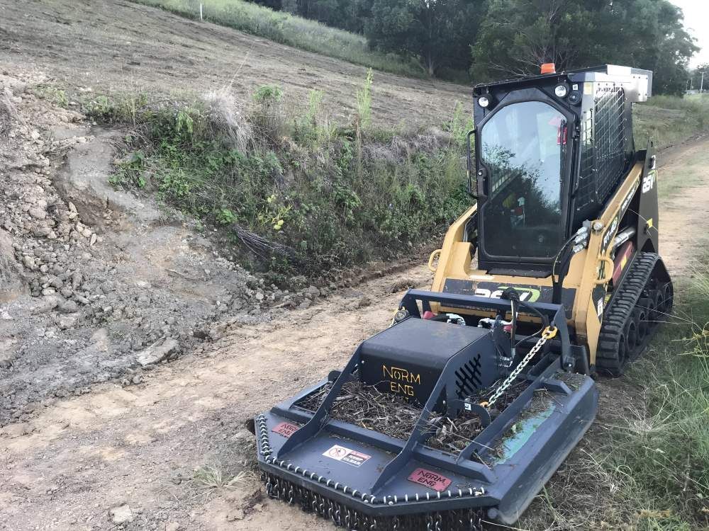 A Small Bulldozer is Sitting on the Side of a Dirt Road — Byron Earth & Road in Wardell, NSW