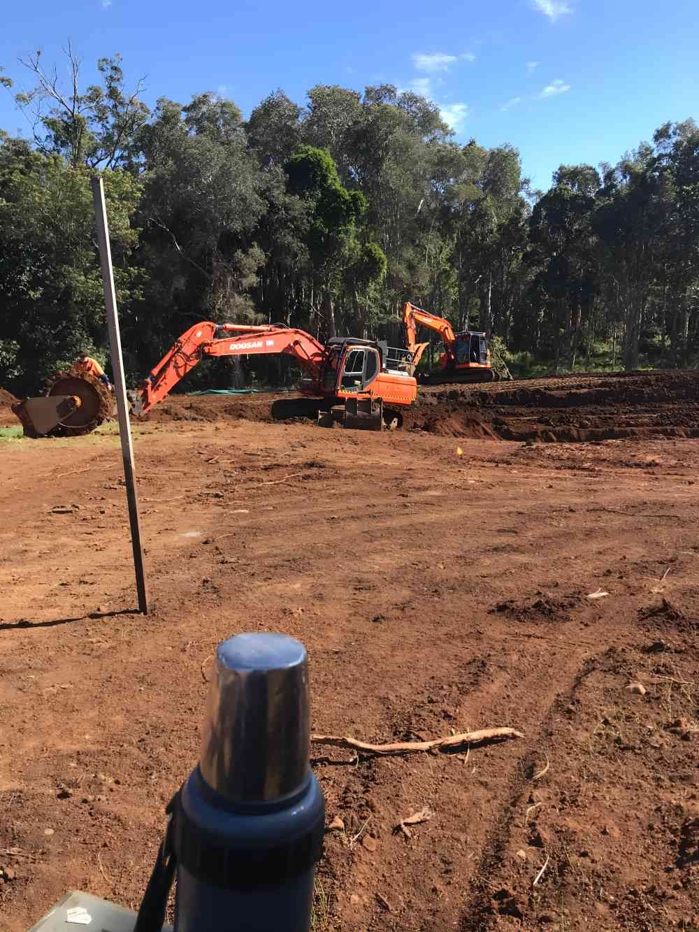 A Group of Construction Vehicles Are Working on a Dirt Field — Byron Earth & Road in Lismore, NSW