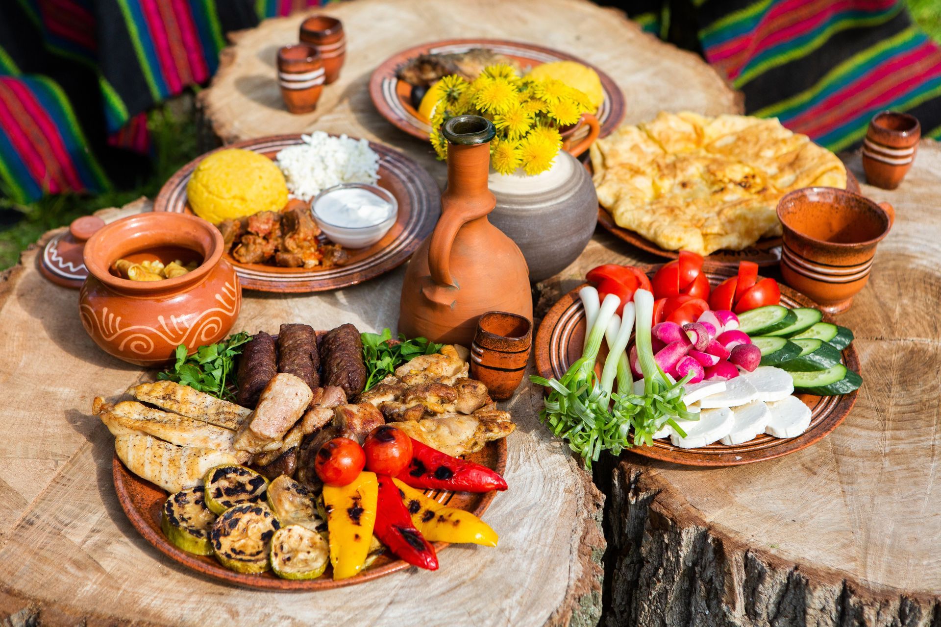 A table topped with plates of food and vegetables.