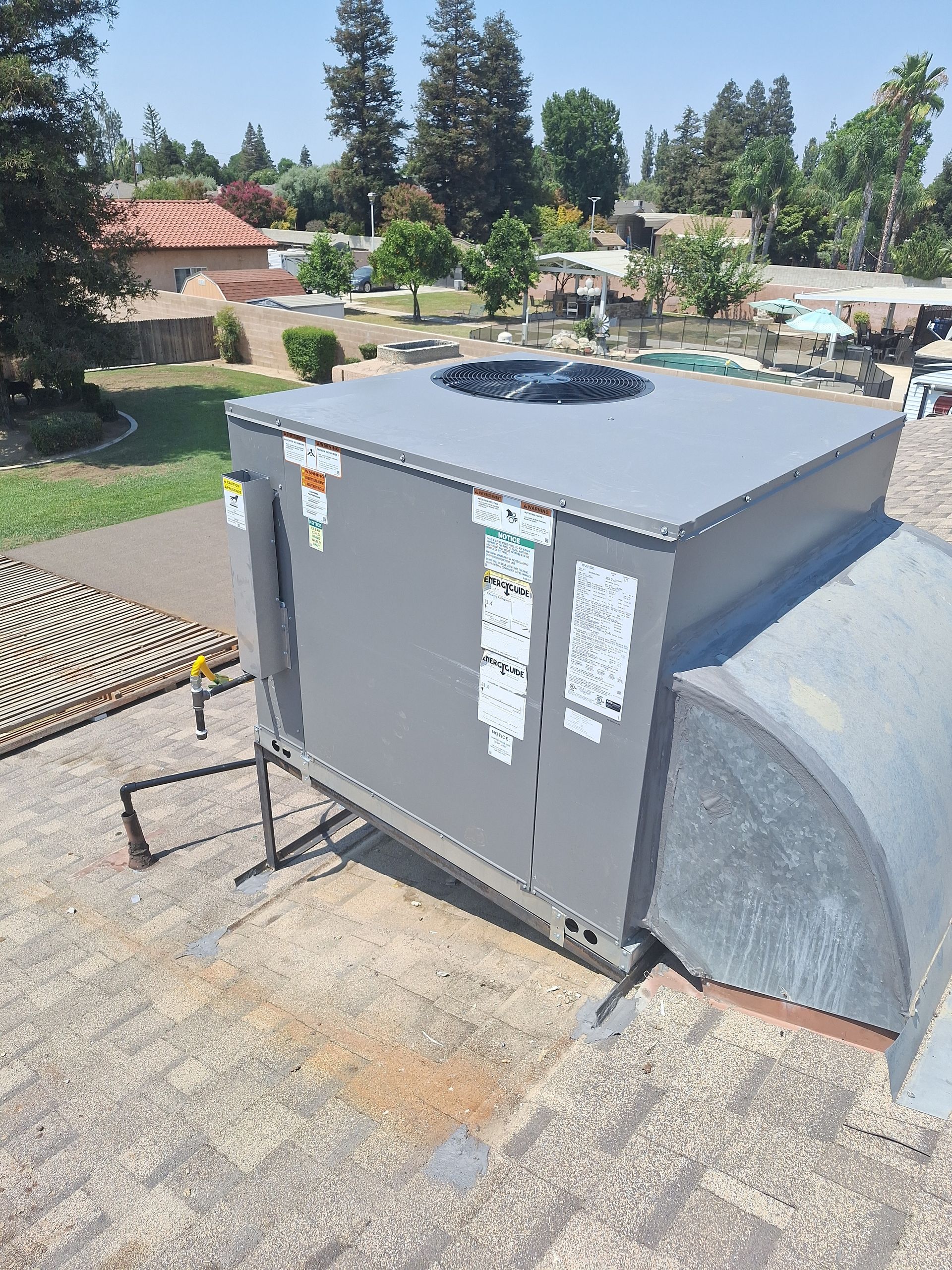 A large gray box is sitting on top of a roof.