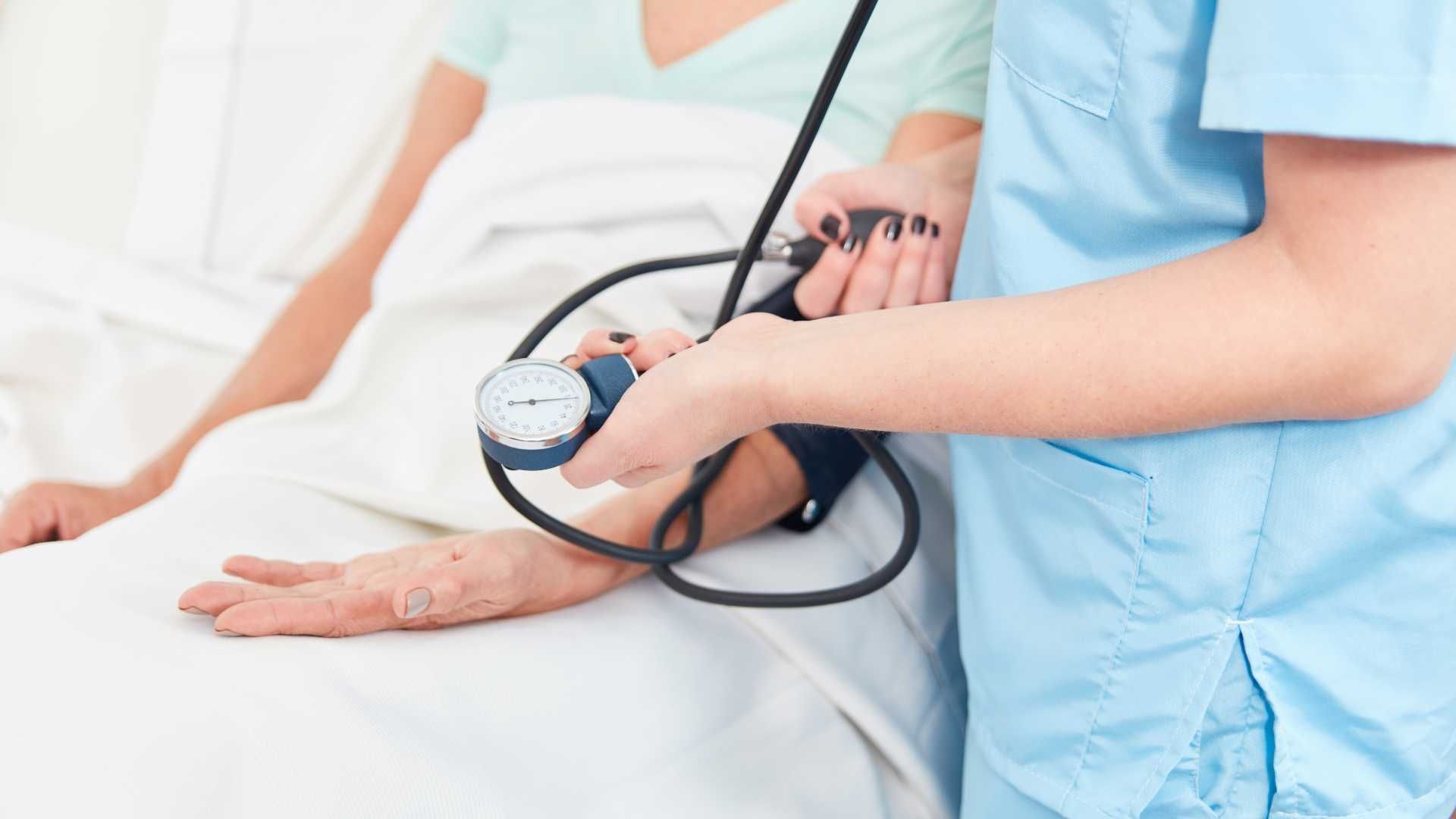 nurse taking patient's blood pressure