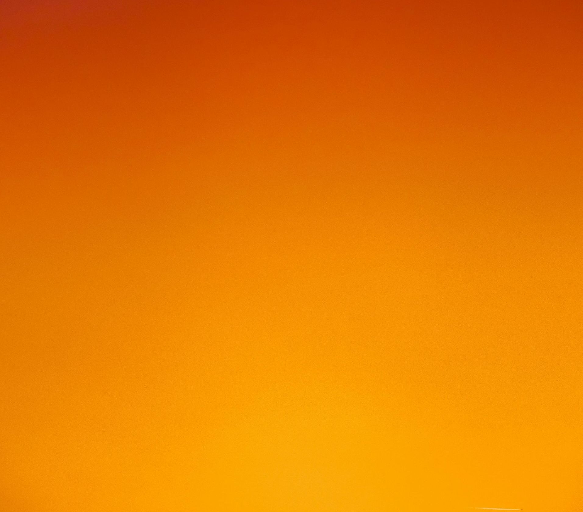 A close up of a bright orange gradient background.