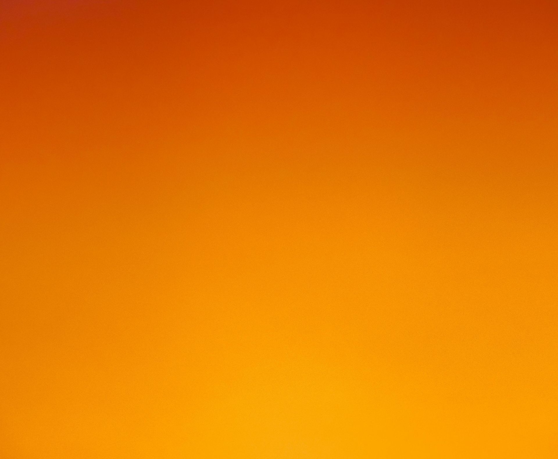 A close up of a yellow and orange gradient background.