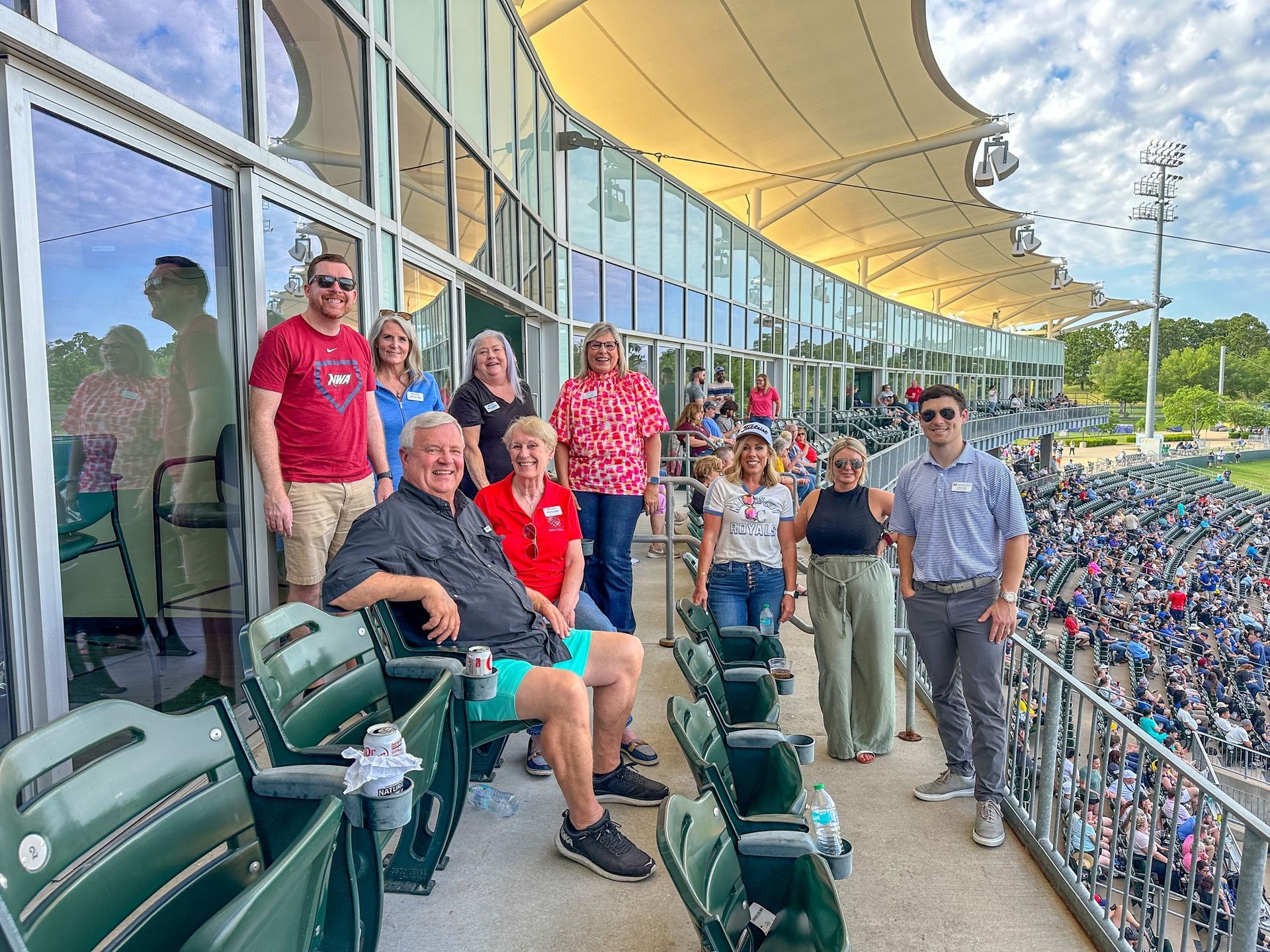 A group of people are sitting in a stadium watching a baseball game.