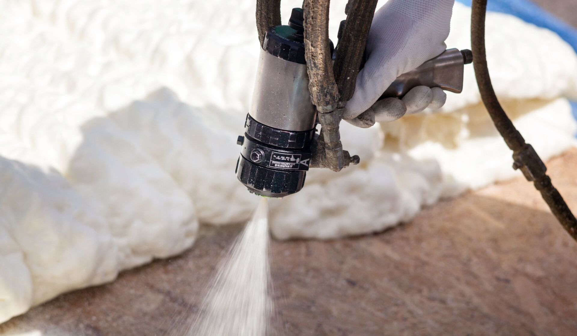 Tulsa spray foam expert cleaning up a job site where closed cell foam was installed