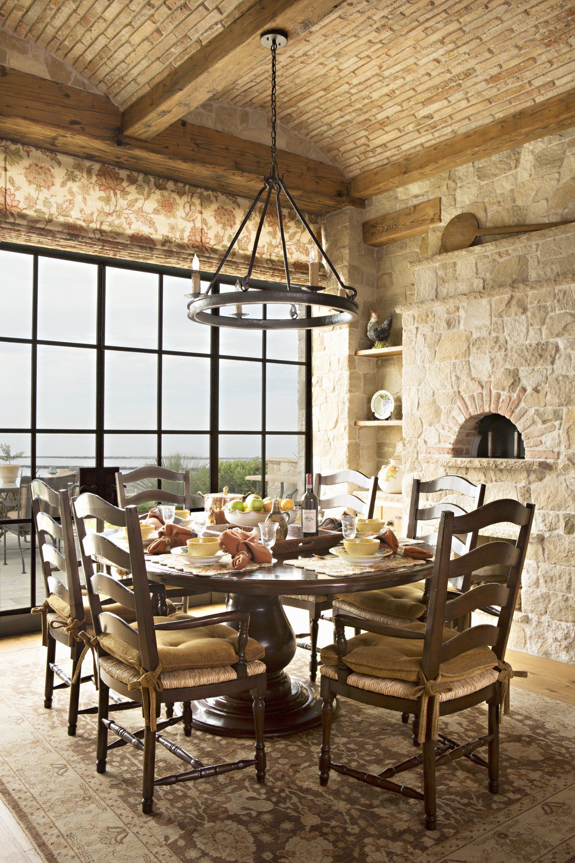 Dining room in a Tuscan stone villa in Corona Del Mar designed by Oatman Architects
