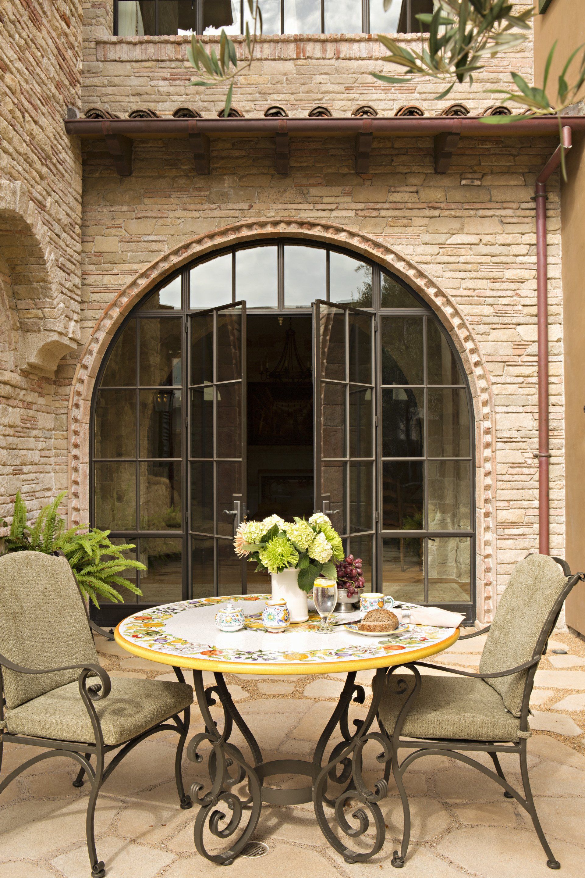 patio of a Tuscan stone villa in Corona Del Mar designed by Oatman Architects