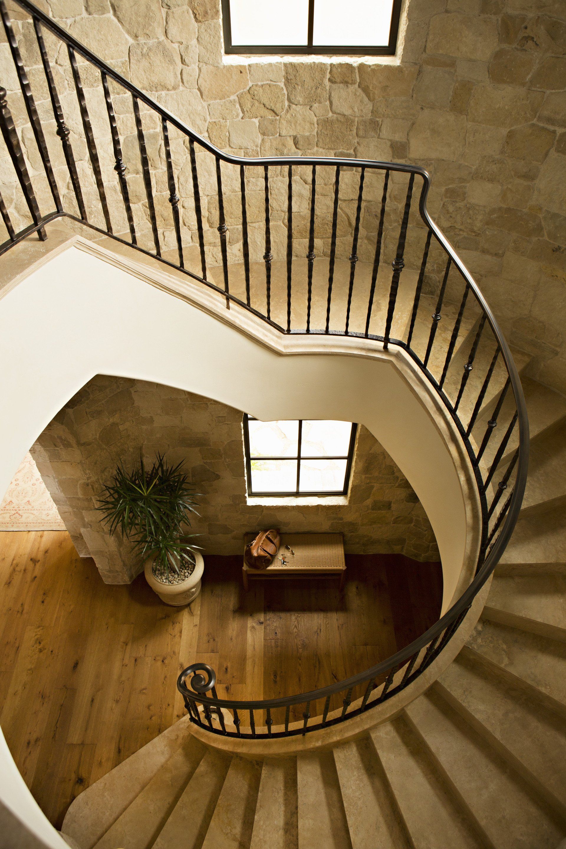 Staircase in a Tuscan stone villa in Corona Del Mar designed by Oatman Architects