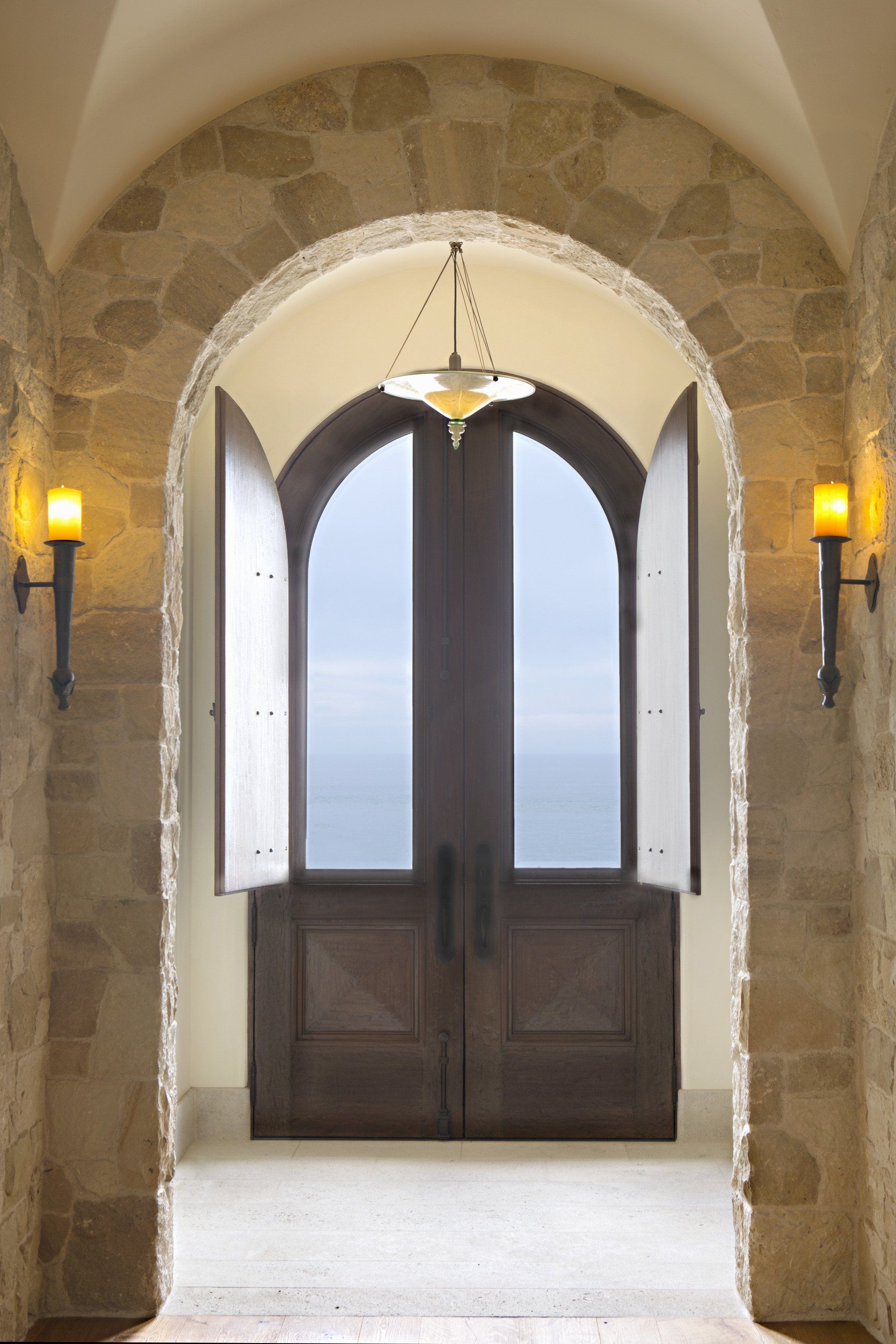 Entrance of a Tuscan stone villa in Corona Del Mar designed by Oatman Architects