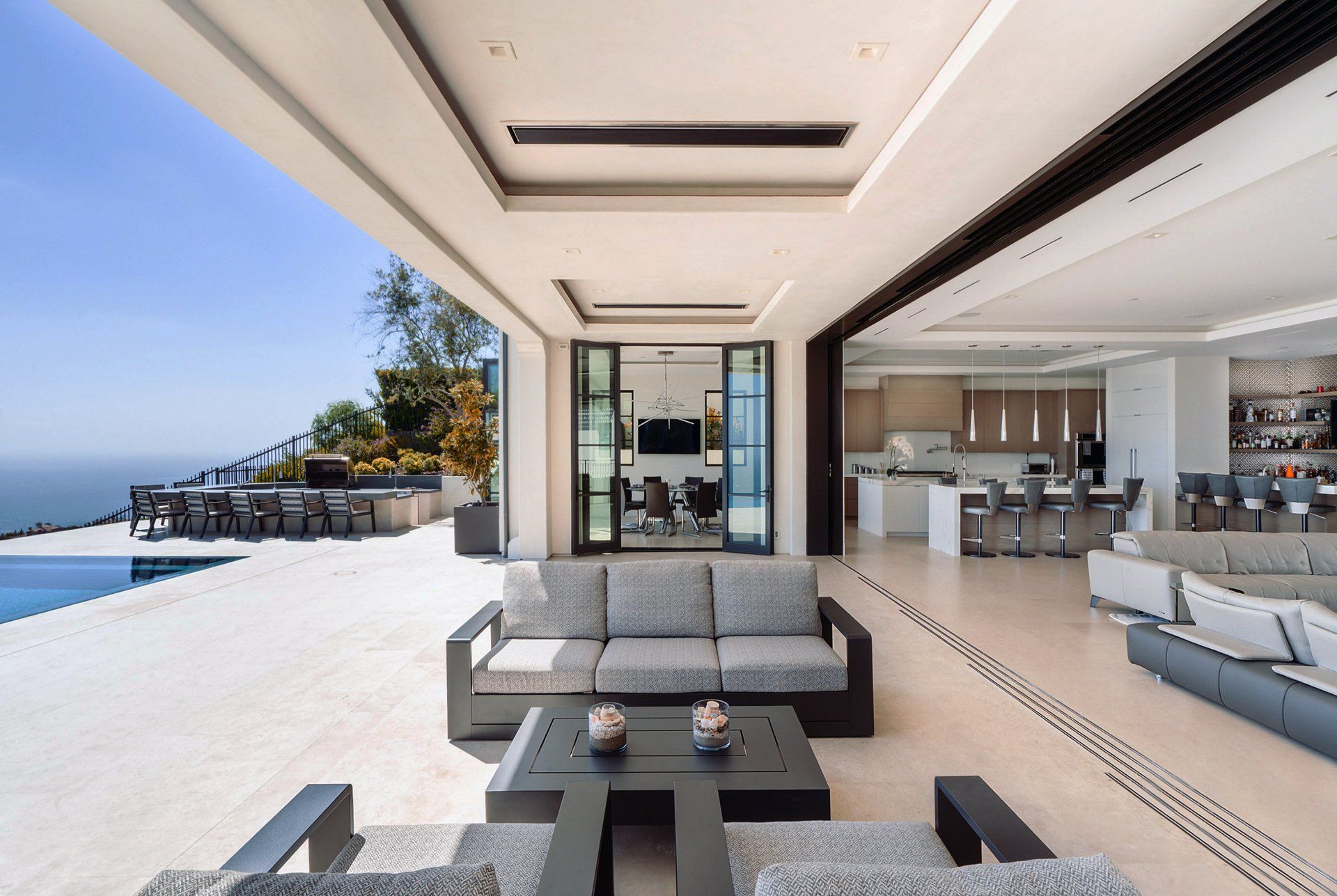 Indoor/outdoor space of Contemporary Spanish Revival house in Corona Del Mar, CA designed by Homer Oatman