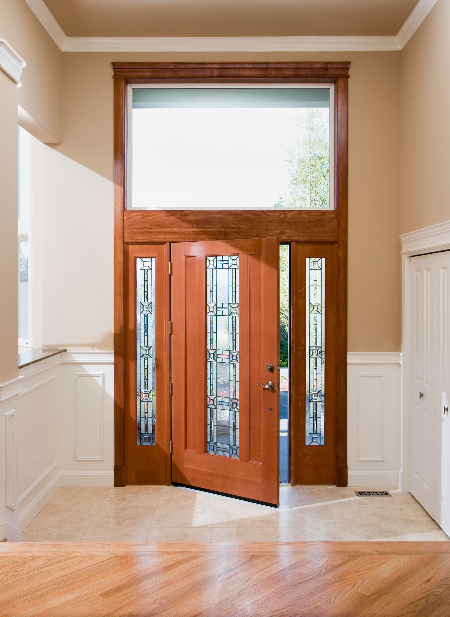 Replacement residential entry doors with wooden design, glass panels, sidelights, and brick frame. Replacement residential entry doors with wooden design, glass panels, sidelights, and brick frame.