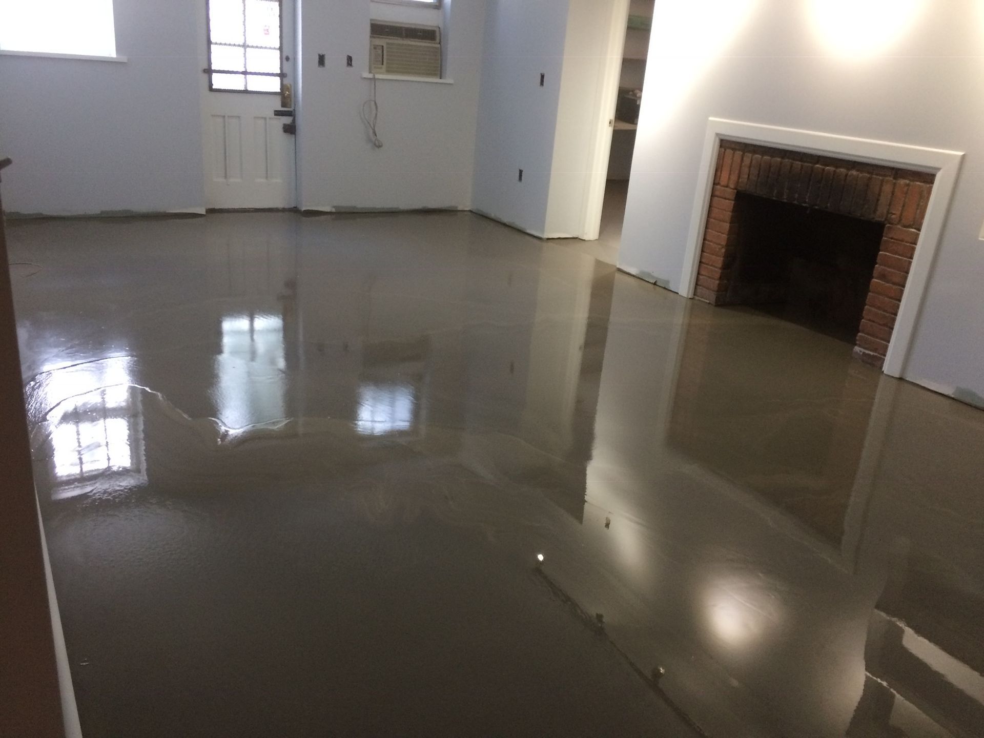 A living room with a fireplace and a shiny floor