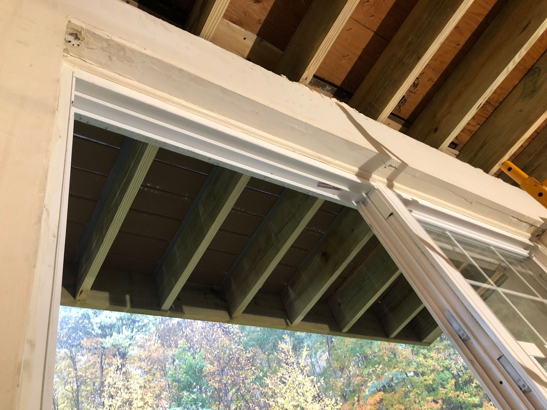 A sliding glass door is being installed in a house under construction