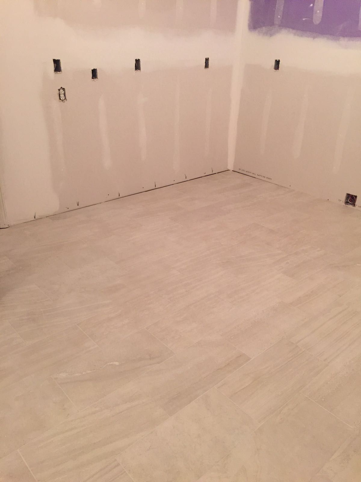 A room with a white tile floor and white walls.