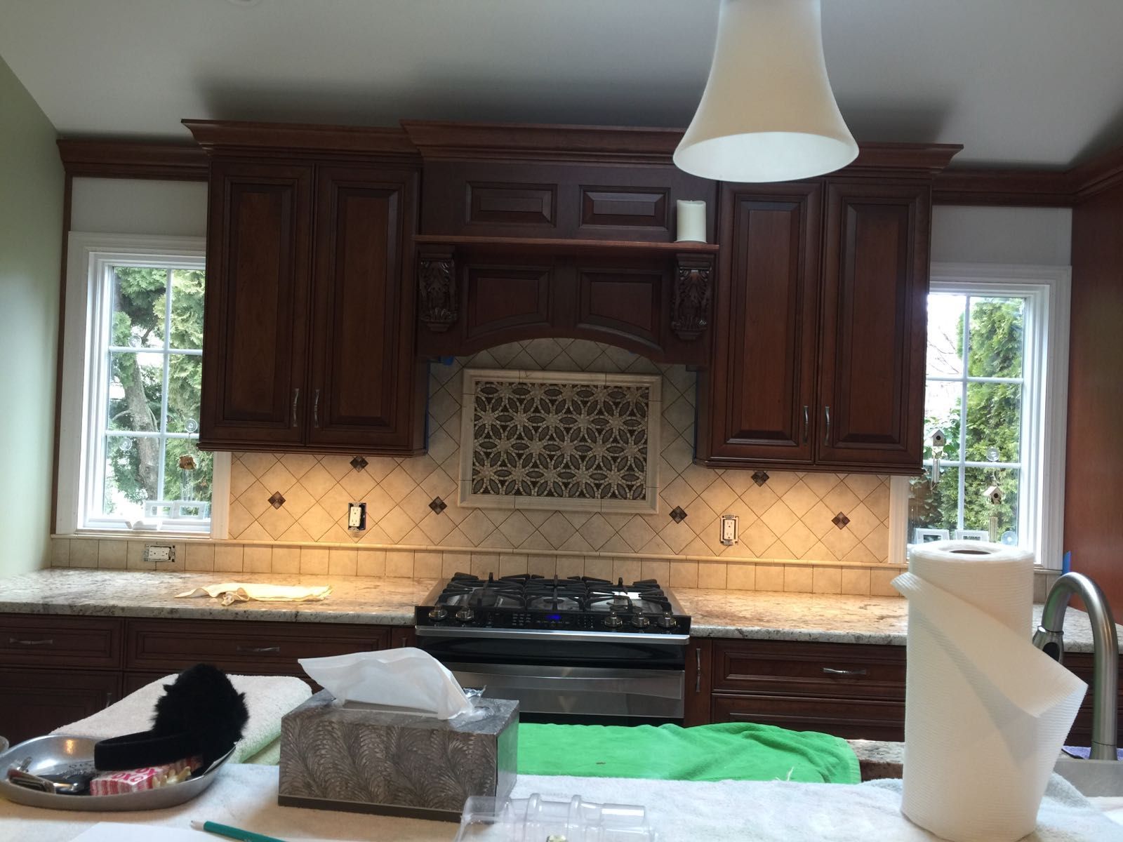 A kitchen with wooden cabinets and a stove top oven