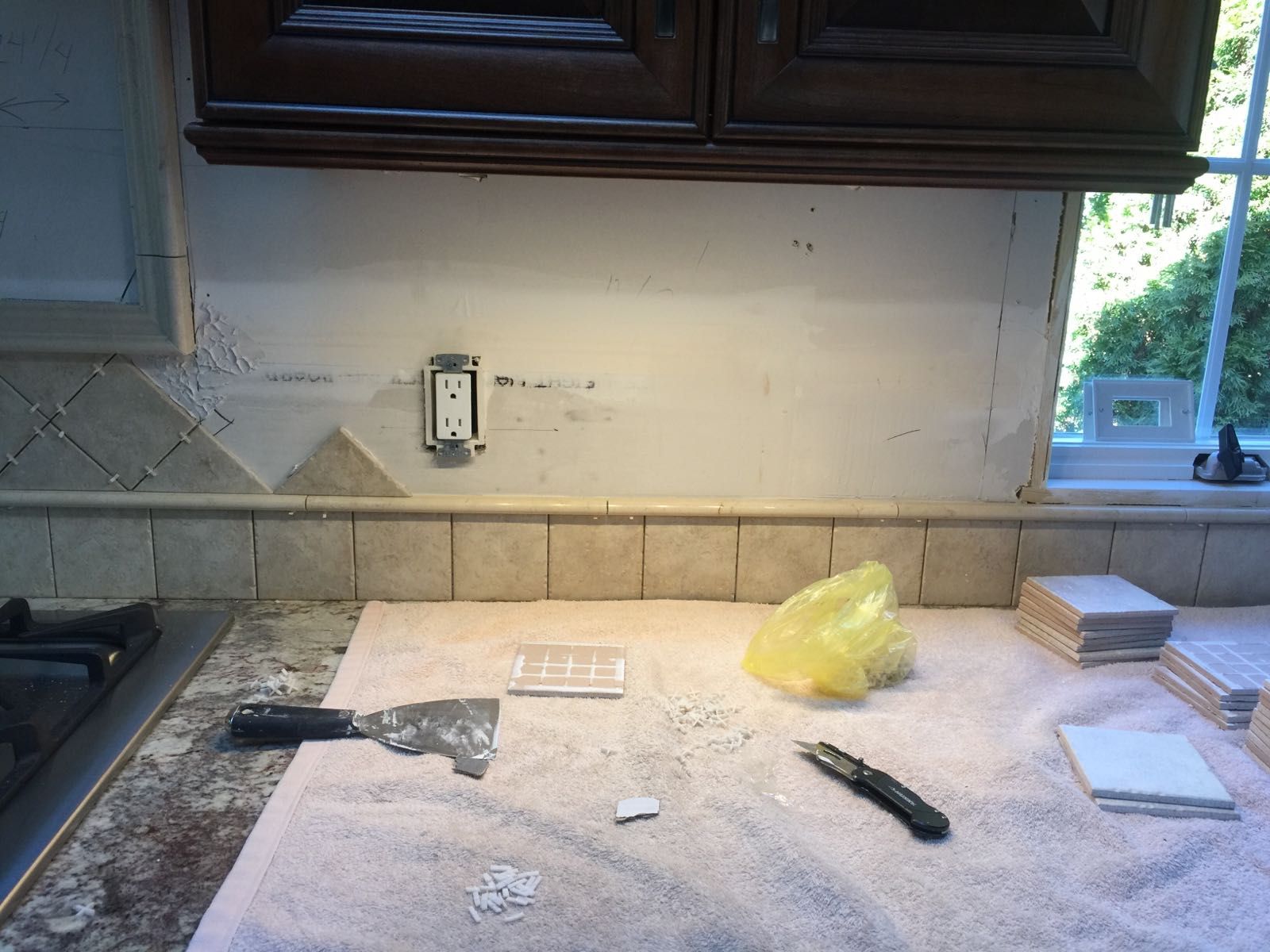 A spatula is sitting on a towel on a kitchen counter.