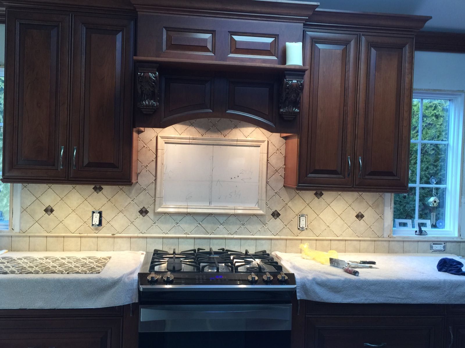 A kitchen with wooden cabinets and a stove top oven