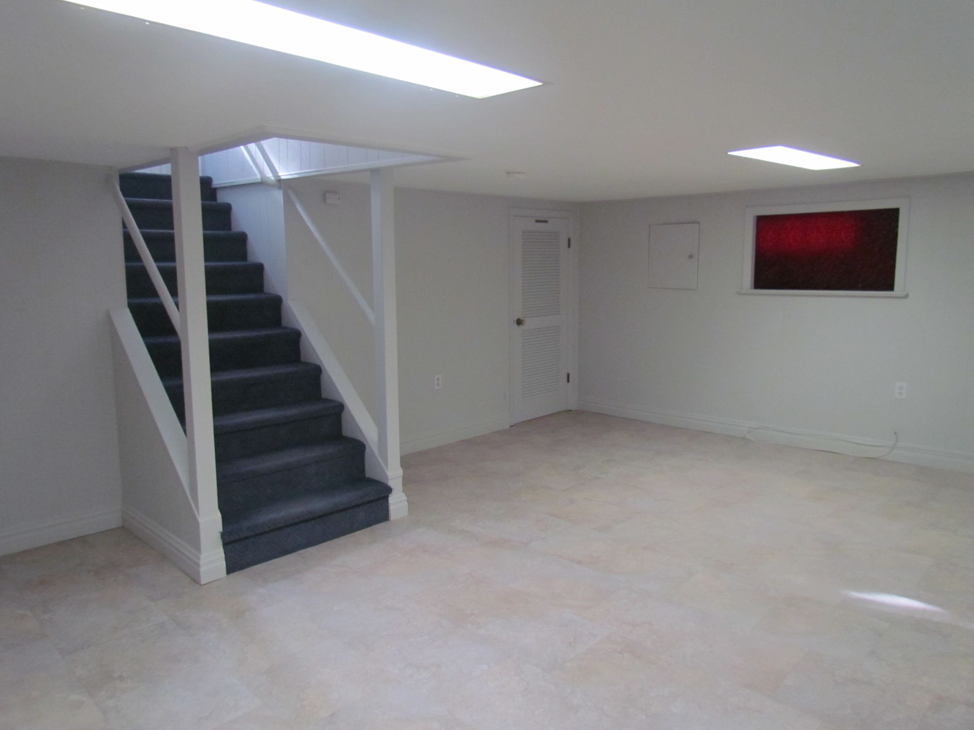 An empty room with stairs leading up to the second floor
