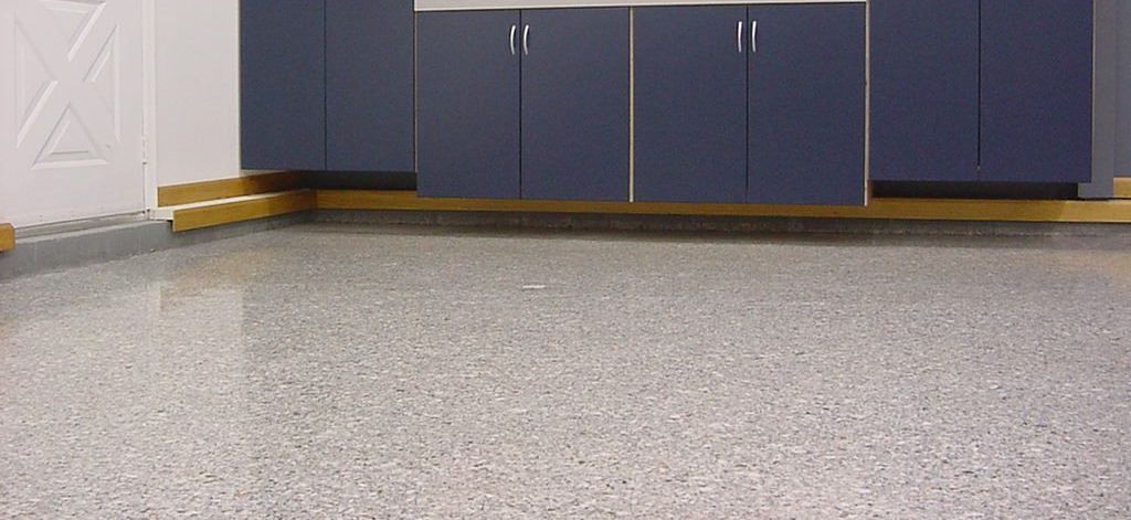 A kitchen with a gray floor and blue cabinets.