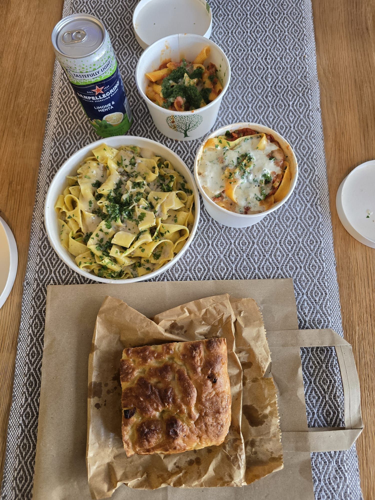 A table topped with bowls of food and a can of soda.